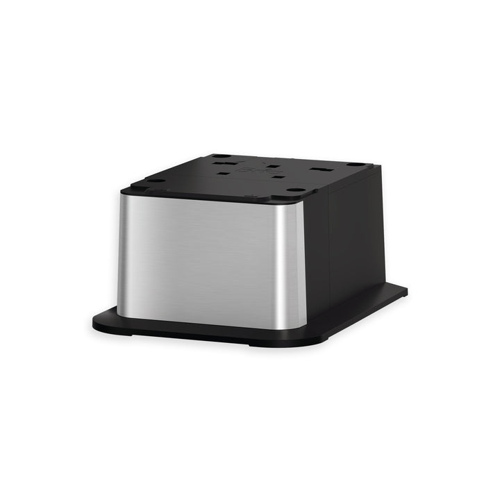 A square, stainless steel tabletop power outlet with multiple sockets, featuring a black base and smooth metallic sides, isolated on a white background.