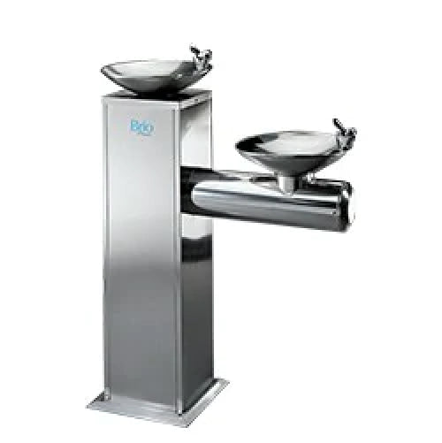 A stainless steel dual-level drinking fountain with two basins at different heights, designed for accessibility and public use, set against a plain white background.
