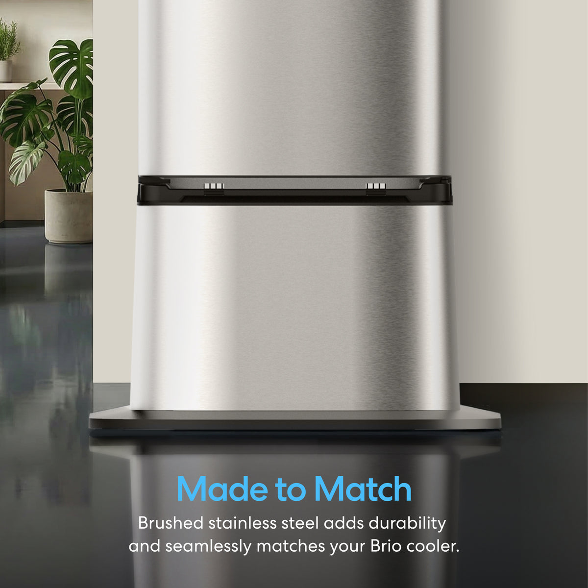 Close-up of a brushed stainless steel appliance on a reflective surface, with plants behind. Text: Made to Match. Brushed stainless steel adds durability and seamlessly matches your Water Cooler Base - 530 Series Bottled & Bottleless.
