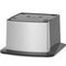 A modern, industrial metallic rectangular device with a brushed steel finish and black accents sits atop the Water Dispenser Cooler Base - 740 Series.