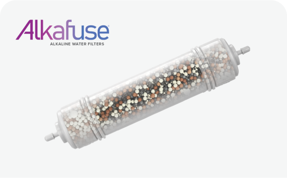 Alkafuse alkaline water filter cartridge with transparent housing, filled with mixed mineral beads in white, brown, and black colors, shown on a white background with the Alkafuse logo in purple and blue.