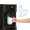 A hand holds a white mug under the Black Bottom Load Water Dispenser - 300 Series, pressing a large push-paddle. Text reads No-Contact Dispensing. The spacious push-paddles enable sanitary water dispensing, and the integrated child safety lock provides peace of mind for families.