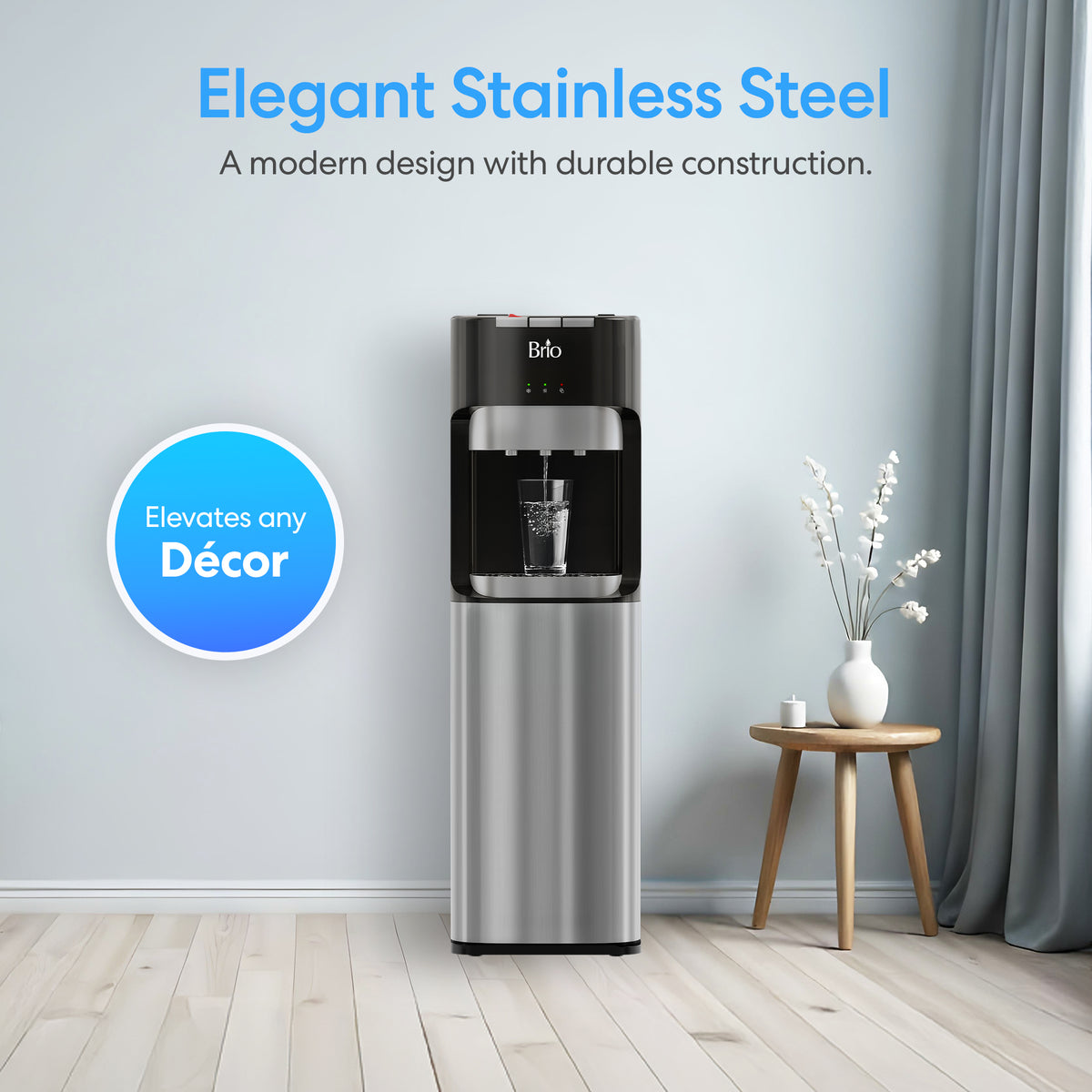 A Bottom Load Water Dispenser - Model 420 stands against a light blue wall near a small wooden table topped with a vase of white flowers. Text highlights the dispenser’s elegant, modern design and its ability to elevate any décor.