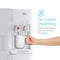 A hand holds a white mug under the 3-Stage White Bottleless Water Cooler - 300 Series, pressing a large push-paddle. Text: No-Contact Dispensing—Large push-paddles and 3-stage filtration deliver sanitary, fresh water every time.