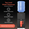 A Top Load Water Cooler Stainless Steel-130 Series in black features a blue water jug and orange cup. The text showcases its durable construction, tall dispense height, dual-temperature dispensing, no plumbing required, and a stainless steel accent panel—all presented on a black and orange background. The cooler offers a convenient no-spill system for effortless bottle changes.