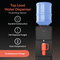The Top Load Water Cooler - 130 Series in black features a tall dispense height, dual temperature dispensing, durable build, a no-spill system, and modern design. Shown with a large blue bottle dispensing water into an orange cup—no plumbing needed.