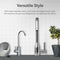 A modern kitchen sink with two stainless-steel faucets in front of a white tiled wall, decorative bowls left, and a lemon potted plant right. Above, text features the Amphora Series Ultrafiltration Under Sink Filtration System’s style and 3-in-1 filter.
