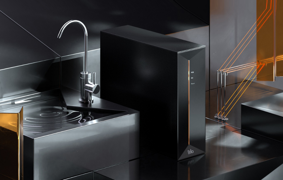 A sleek, modern kitchen sink area with a metallic faucet and a black, rectangular device labeled Bio on the counter, featuring glossy surfaces and orange accent lines in the background.