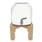 The GEO Porcelain Ceramic Crock Water Dispenser w/ Stand - White features a BPA-free ceramic body with metal spigot, minimalist open-top design, and sits on a light wood four-legged stand.