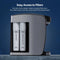 The Stainless Steel Bottleless Countertop Water Dispenser - Model 820 features an open side panel that reveals two filter cartridges labeled SEDIMENT and CARBON BLOCK, showcasing its 2-stage filtration system designed for easy filter access and replacement.