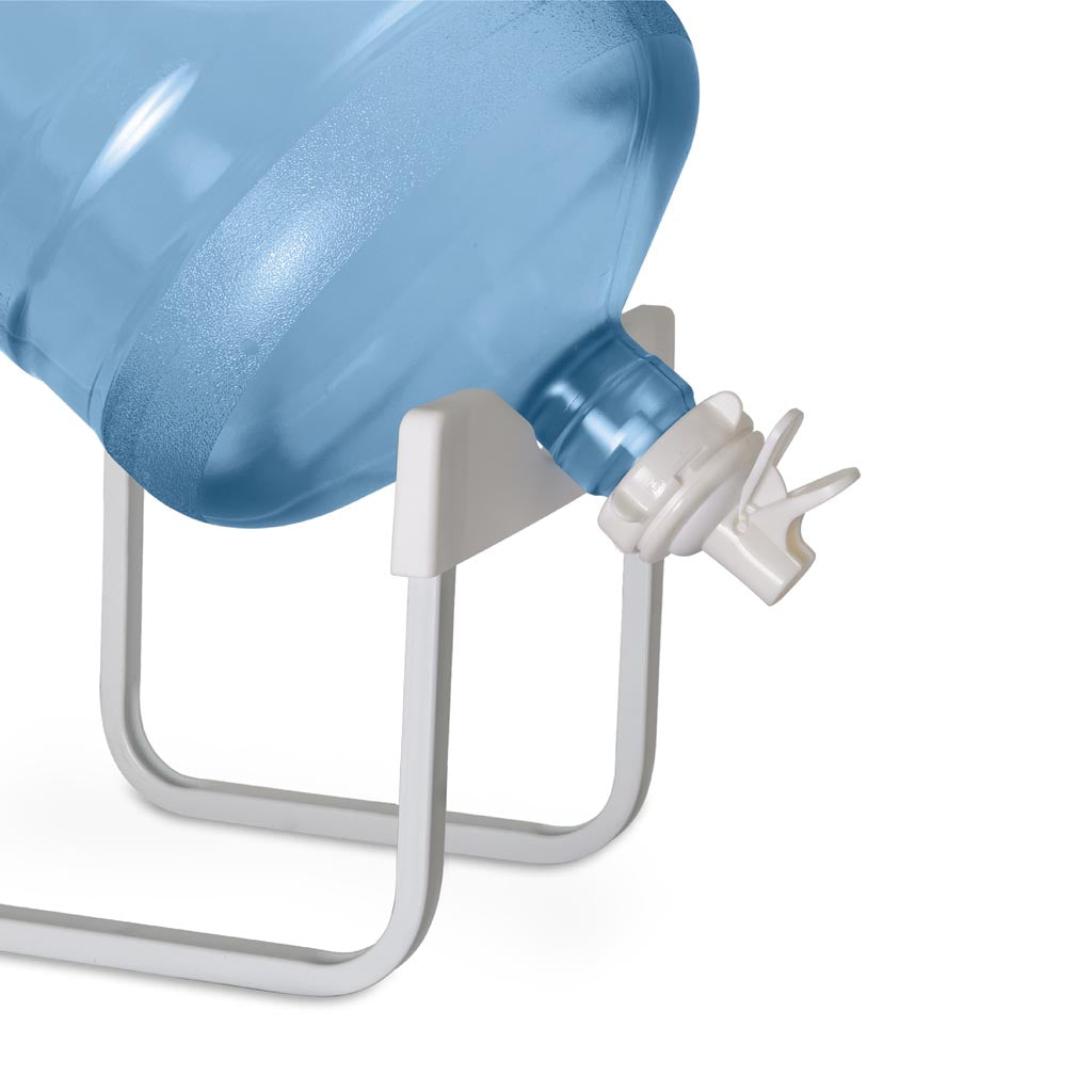 A large blue water jug with a white spigot rests on its side on the Brio Stainless Steel Single Water Bottle Stand - White, set against a white background.