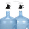 The Metal Foldable Bottle Stand - Black includes two large water jugs with different neck designs, each shown with its own black screw cap valve. Both valves are provided, and the set features a foldable stand for convenience.