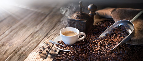 Cup of Coffee With Grinder and Coffee Beans