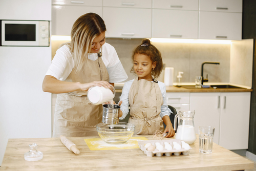 A mother and daughter baking together in the kitchen