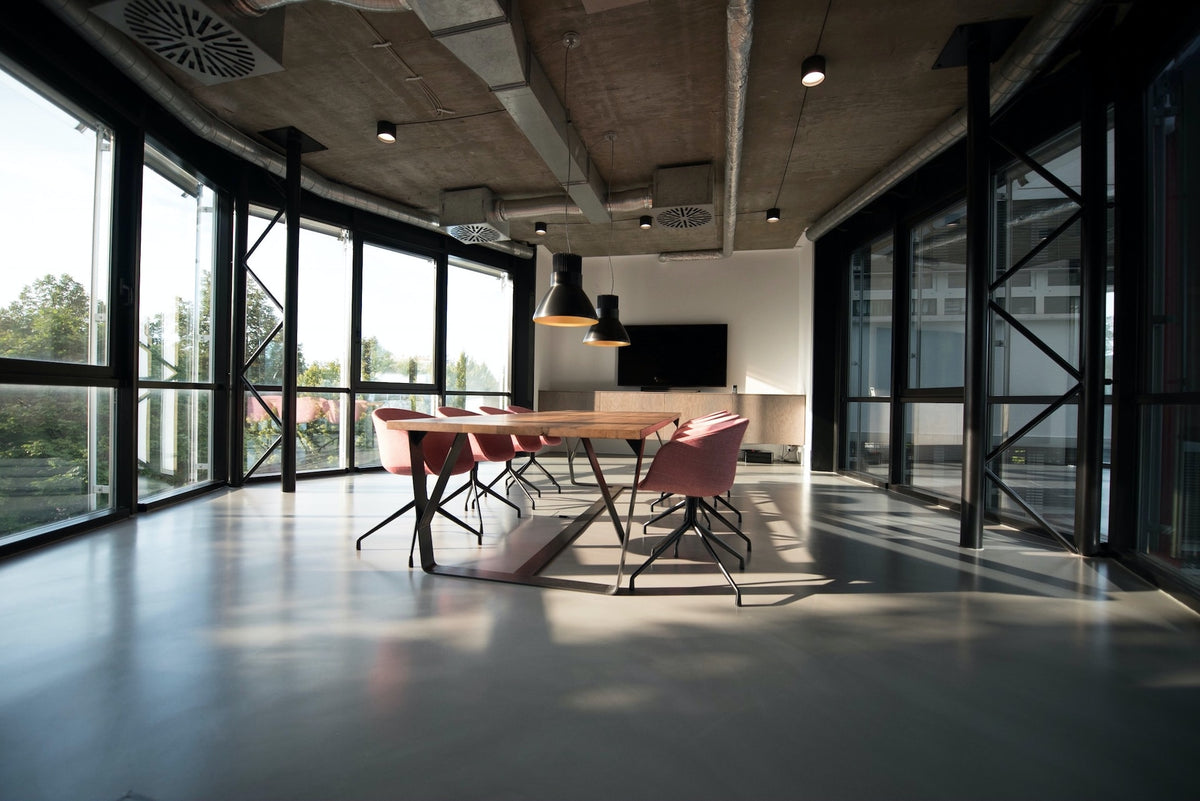 minimalist, modern large office room with floor to ceiling windows