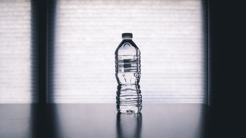 plastic water bottle standing on a kitchen worktop