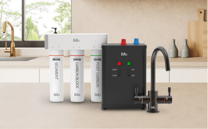Brio undersink hot water filtration system with three filters, a black heating unit, and a matching black faucet installed on a kitchen counter.
