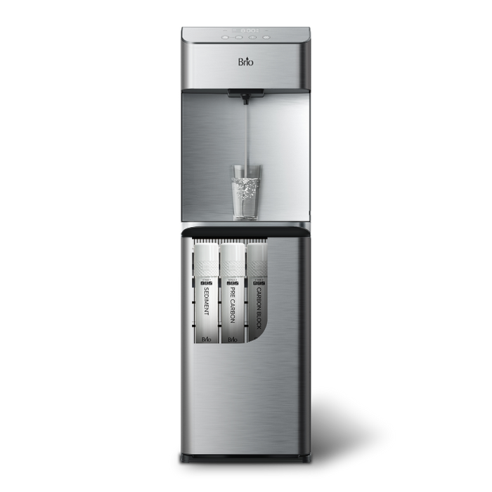 A stainless steel water dispenser with a glass of water being filled and three visible filter cartridges in the lower compartment.