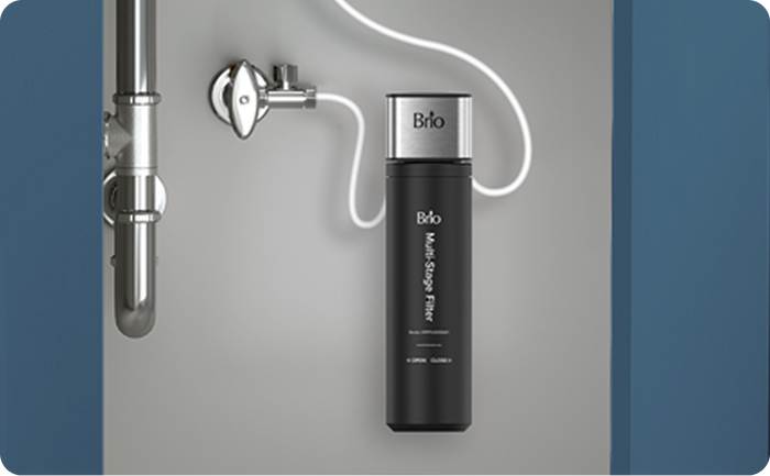 Brio Multi-Stage Filter single housing unit installed under a sink with connected white tubing and chrome pipes.