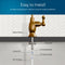 Diagram showing a Curvy Classic Series Water Faucet - Brushed Bronze installed in a countertop with labeled parts: rubber washer, locking nut, 4" threaded shank, locking clip, 1/4" quick connect, and 1/4" PE tubing. Text: Easy to Install.