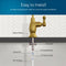The diagram shows a Curvy Classic Series Water Faucet - Brushed Gold installed through a countertop, with labeled parts: rubber washer, locking nut, 4" threaded shank, locking clip, 1/4" quick connect, and 1/4" PE tubing.