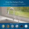 A Curvy Classic Series Water Faucet-Chrome is featured in a modern kitchen with two sleek faucets beneath a bright window. Six finish options—brushed gold, brushed bronze, brushed nickel, chrome, matte black, and white—are shown below.