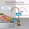 The Modern Series Water Faucet in brushed bronze features a 360° rotating spout, dispensing water onto a green apple on a kitchen counter next to the sink. Labeled arrows showcase its impressive movement range.