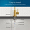 A diagram displays the components of a Modern Series Water Faucet - Brushed Gold installation: rubber washer, locking clip, 4" threaded shank, 1/4" quick connect, and PE tubing for your reverse osmosis faucet on a tiled backsplash.