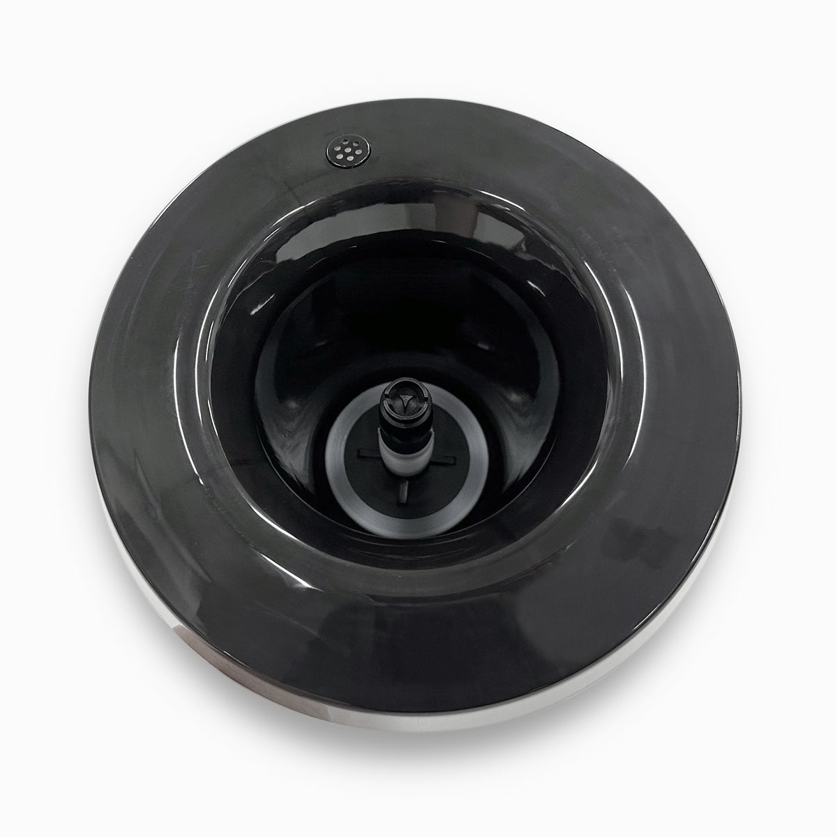 Top view of the Non-Spill Top 520CV Coolers Black, a circular black appliance part with a central spindle and vent holes near the edge, compatible with CL520CV and CL525CV models, shown on a white background.