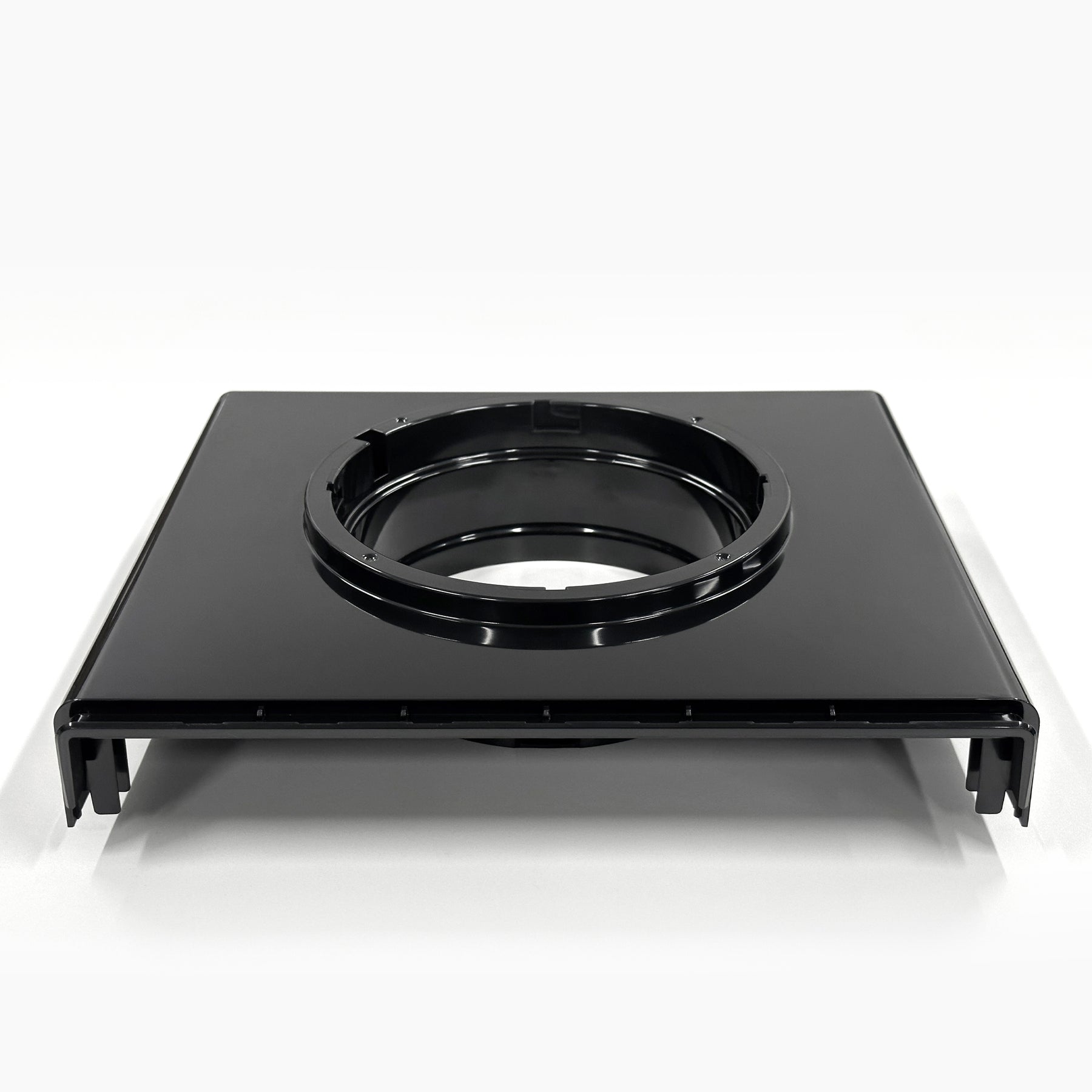 The Top Lid 520 for Top Load Coolers is a black rectangular plastic component with a large central circular opening. Seen from the front, it features raised edges and a glossy finish that gives it a sleek look.