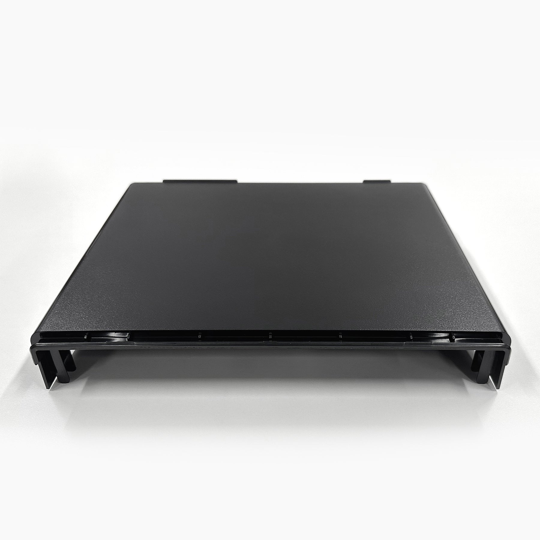A black, rectangular plastic Top Lid for 720 Series Coolers with slightly raised edges, shown front-facing against a white background. It has small side and rear tabs or clips for secure placement.