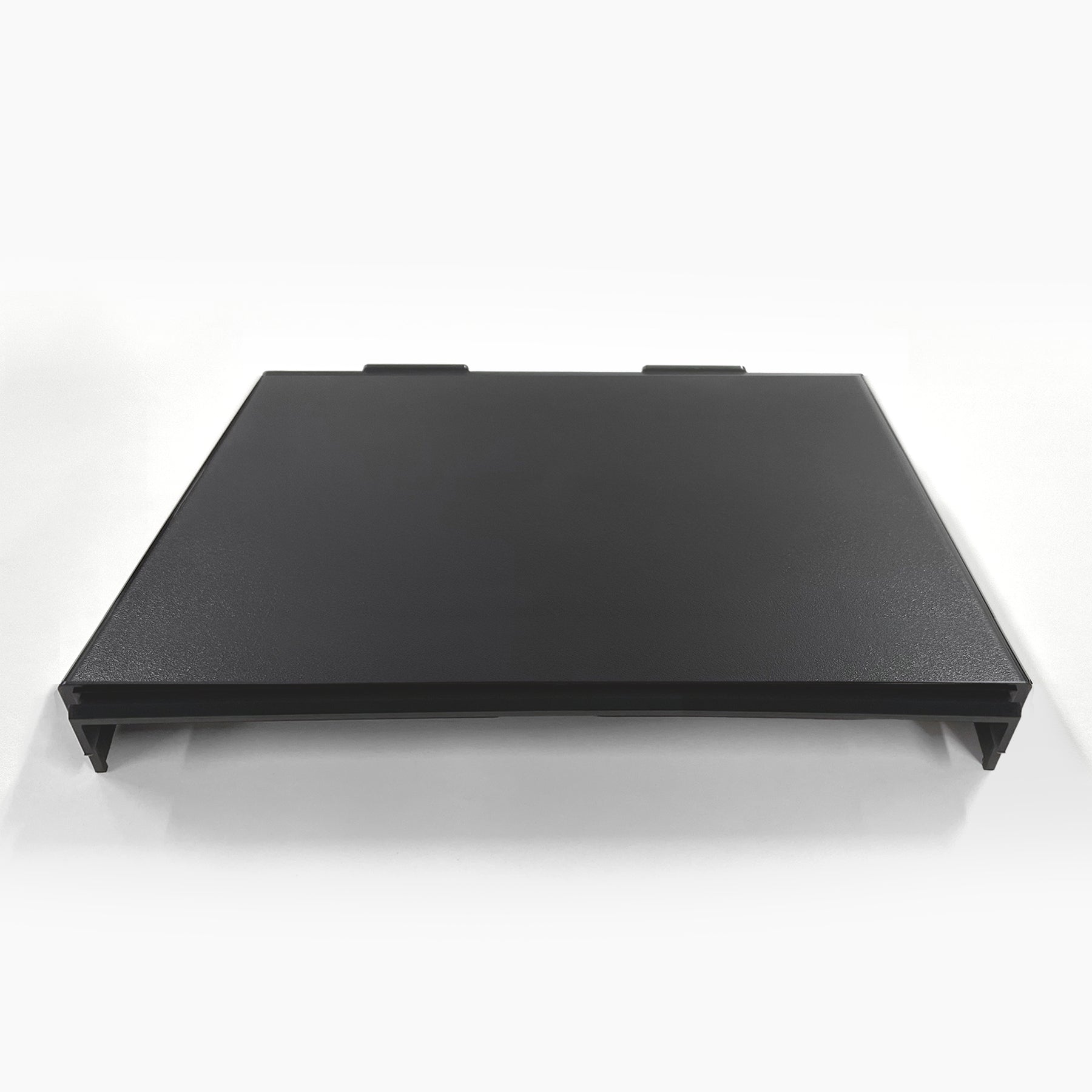 A black, rectangular Top Cover for Brio 320, 420 & 520 Series Icemaker Coolers with two tabs on the back edge, shown flat on a white surface against a plain white background.