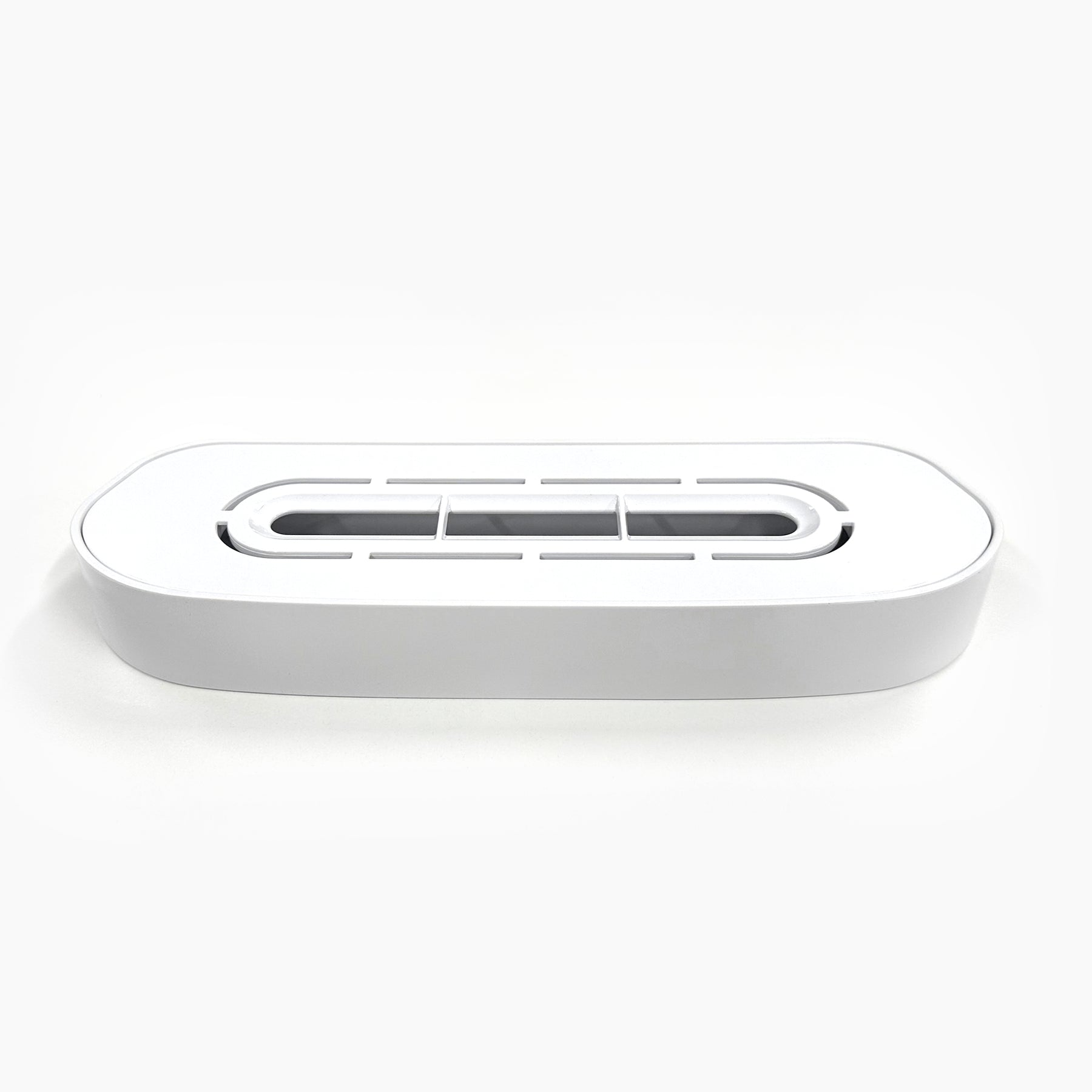 The Drip Tray and Cover 320 White Bottom Load is a rectangular white plastic tray with rounded edges and a vented lid, ideal for organizing and concealing electrical cords.
