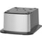 A modern, metallic square unit with multiple top plug sockets and brushed silver sides, mounted on a black base inspired by the Cooler Base For 420 & 520 Series Icemaker Dispensers for sleek functionality.