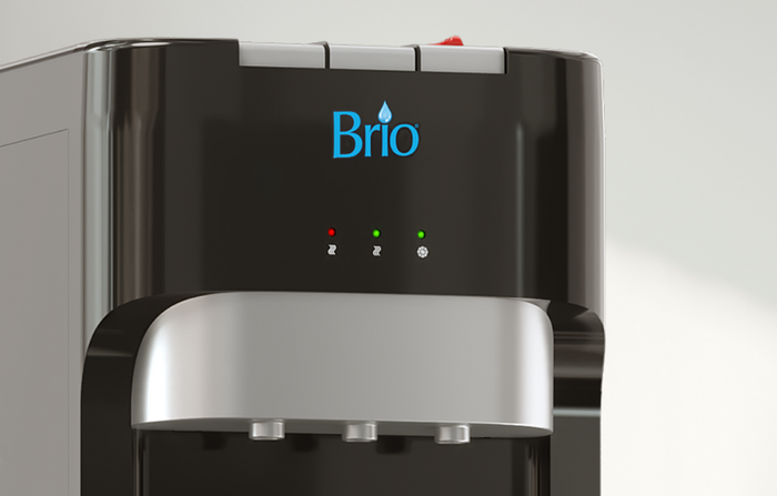 Close-up of a Brio water dispenser showing the blue Brio logo, three indicator lights (two green, one red), and three water spouts below a silver panel. The background is out of focus.