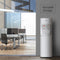 The White Bottom Load Water Cooler - 300 Series with hot and cold dispensers stands by a glass-walled modern office. Versatile design text appears on the wall. Features a child safety lock for added peace of mind.