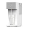 The SIMPL W3 Countertop 2-in-1 Mineralization Water Filter Dispenser in white features a digital display, touch controls, and a visible refillable tank while pouring filtered water into a glass.