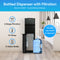 Black Stainless Bottom Load + Water Filtration Dispenser - 520 No-Line, featuring a spacious bottom compartment that easily fits a 5-gallon bottle. Labeled features include a 2-stage water filtration dispenser system, tri-temperature settings, and generous 5-gallon capacity. Set against a sleek kitchen background with blue info bubbles for clear feature highlights.
