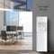 A 3-Stage White Bottleless Water Cooler - 300 Series stands near a glass-walled office with desks and chairs, with "Versatile Design" displayed above the dispenser.