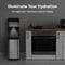 A 3-Stage Bottleless Water Filtration Dispenser - 430 Series with LED night light and illuminated indicator display stands next to a kitchen counter and oven, offering advanced 3-stage filtration. Above, the text “Illuminate Your Hydration” and “LED Night Light | Illuminated Indicator Display” showcase its modern design.