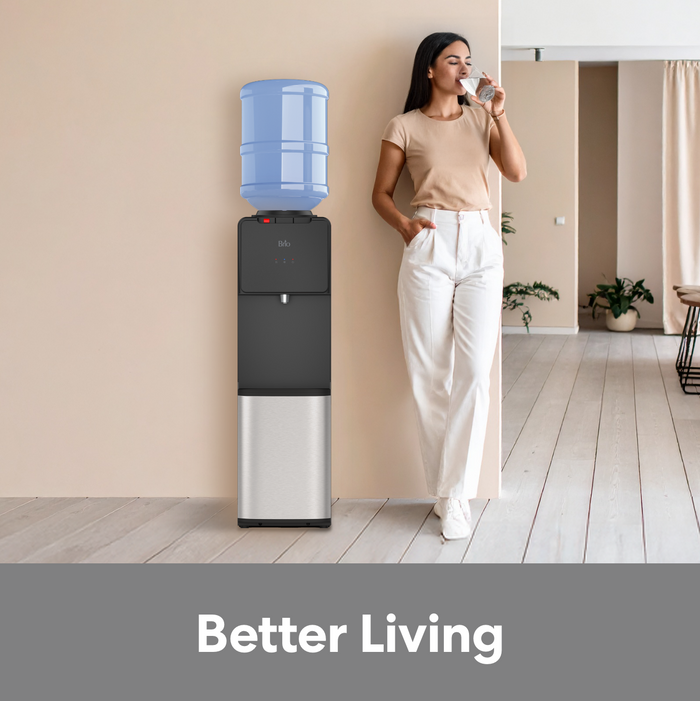 Young woman drinking a glass of water from the Brio 130 Series Top Load Water Dispenser.