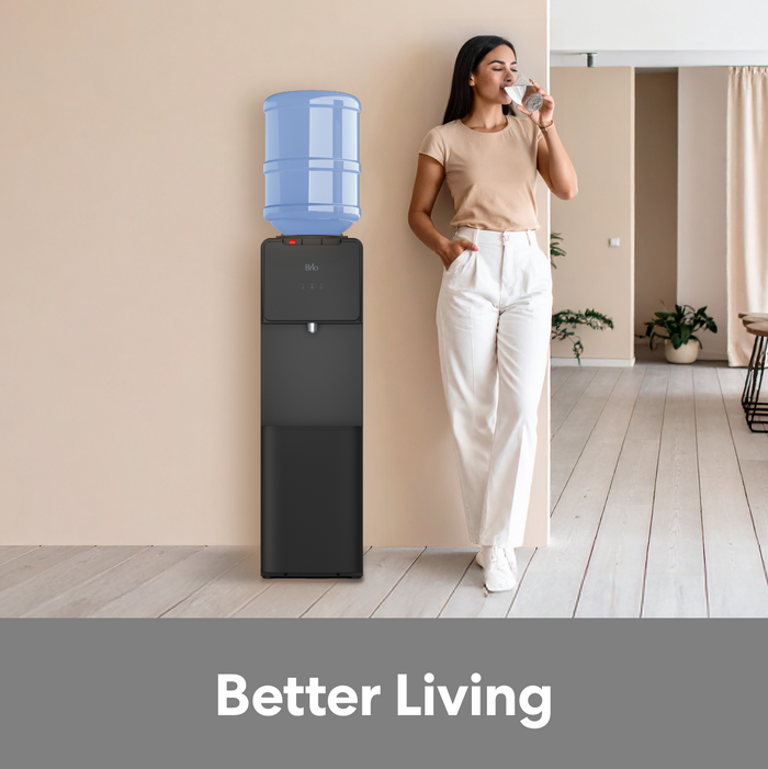 Young woman drinking water from the Brio  130 series top load water cooler.