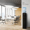 A modern office with white desks and chairs, large windows, and a sleek Black Top Load Water Cooler - 320 Slim Series featuring blue and red taps. Text reads NEW Slim Design.