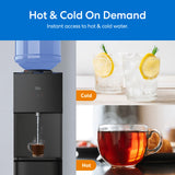 A Brio 530 Series Hot & Cold Top Load Water Cooler dispenses hot water into a cup. Nearby, images show iced lemon water labeled Cold and a steaming tea cup labeled Hot. Text: Hot & Cold On Demand.