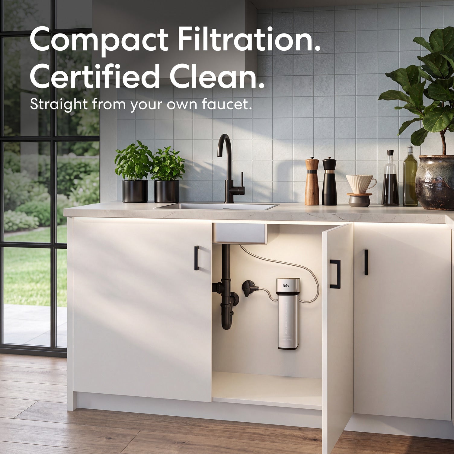 The 11″ Premium Under Sink Filter PFAS-Reduction System mounted on a white kitchen cabinet door, shown in a bright modern kitchen with the text 'Compact Filtration. Certified Clean.