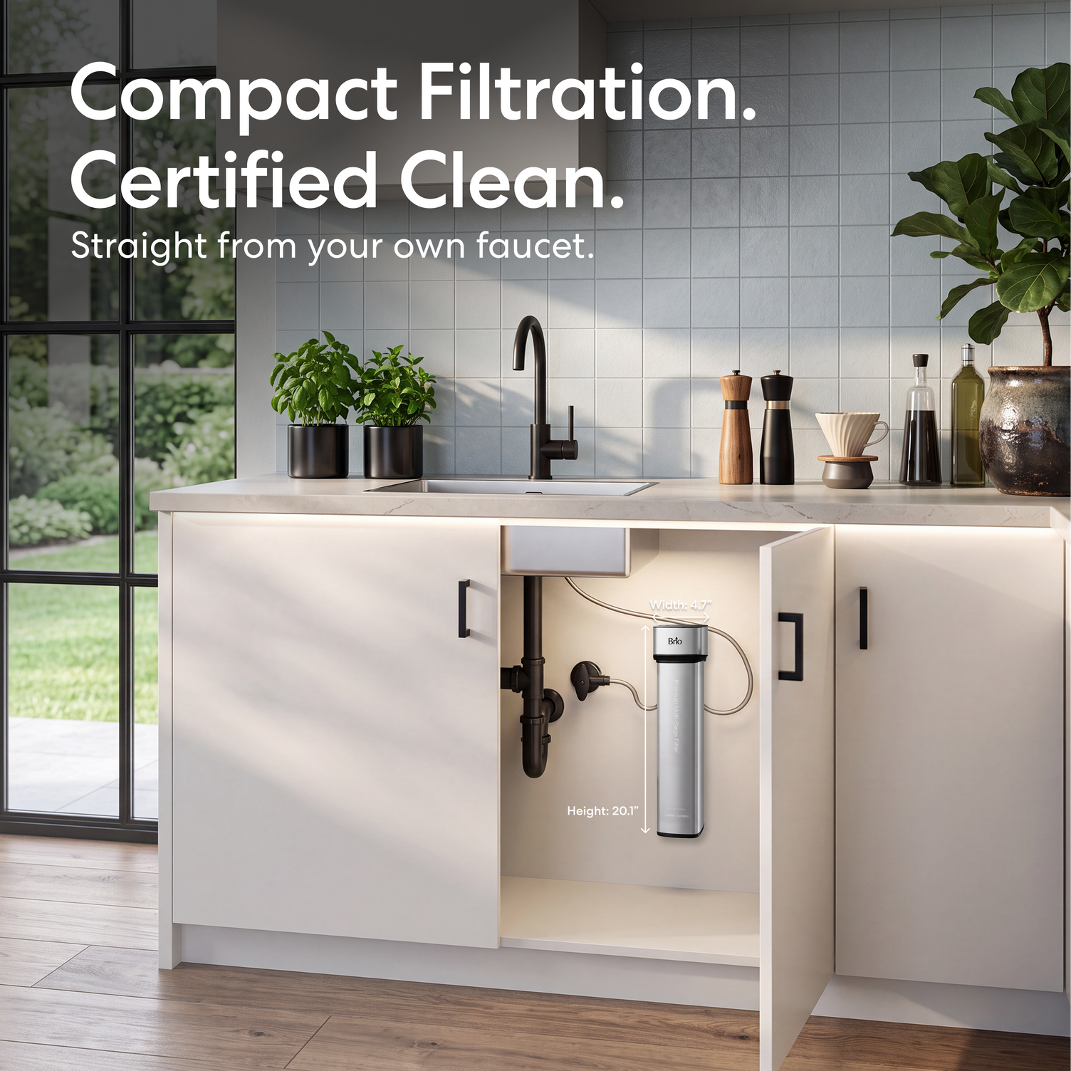 The 16″ Premium Under Sink Filter PFAS-Reduction System mounted on a white kitchen cabinet door, shown in a bright modern kitchen with the text 'Compact Filtration. Certified Clean.