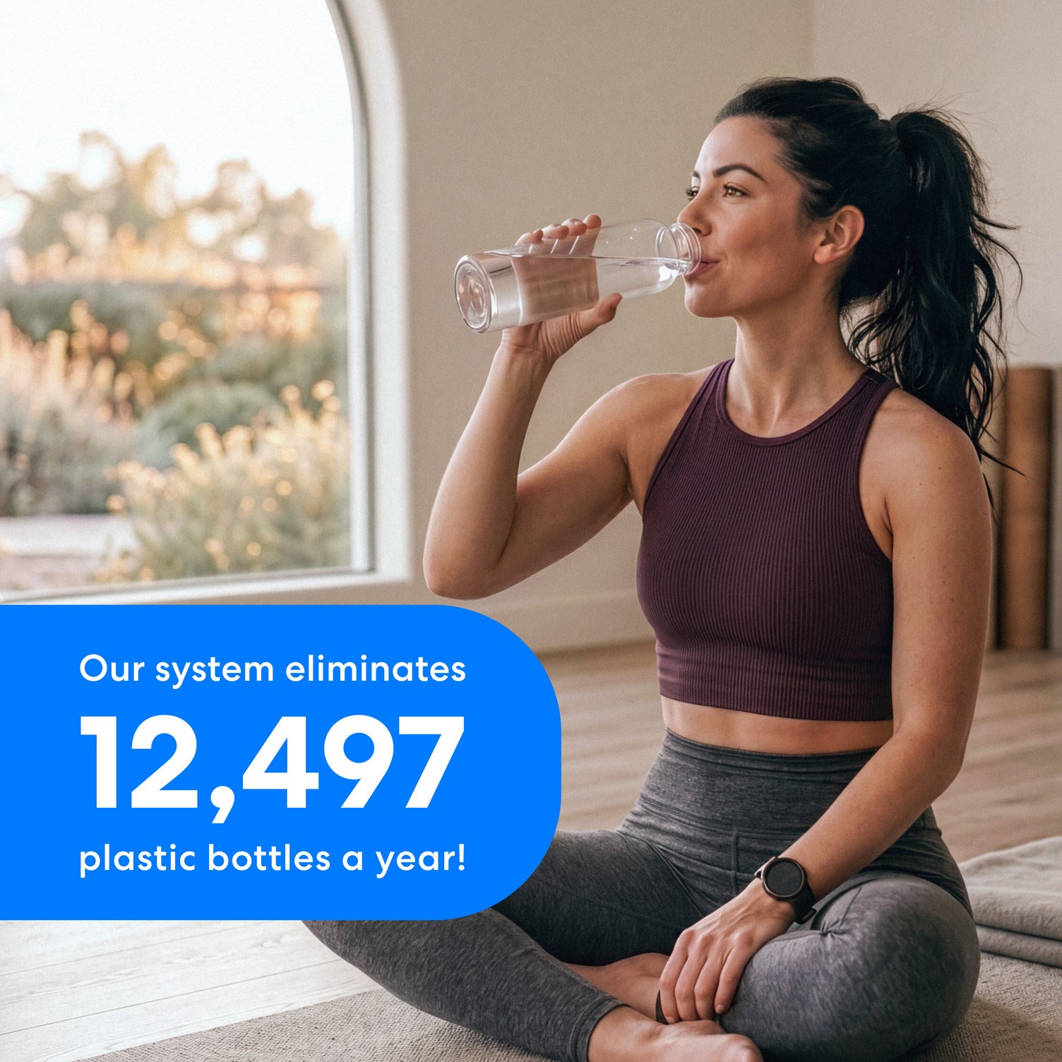 Image of a woman in workout clothing sitting on the floor drinking water to illustrate that the Brio 22″ Premium Under Sink Filter PFAS-Reduction System eliminates up to 12497 plastic bottles in one year.
