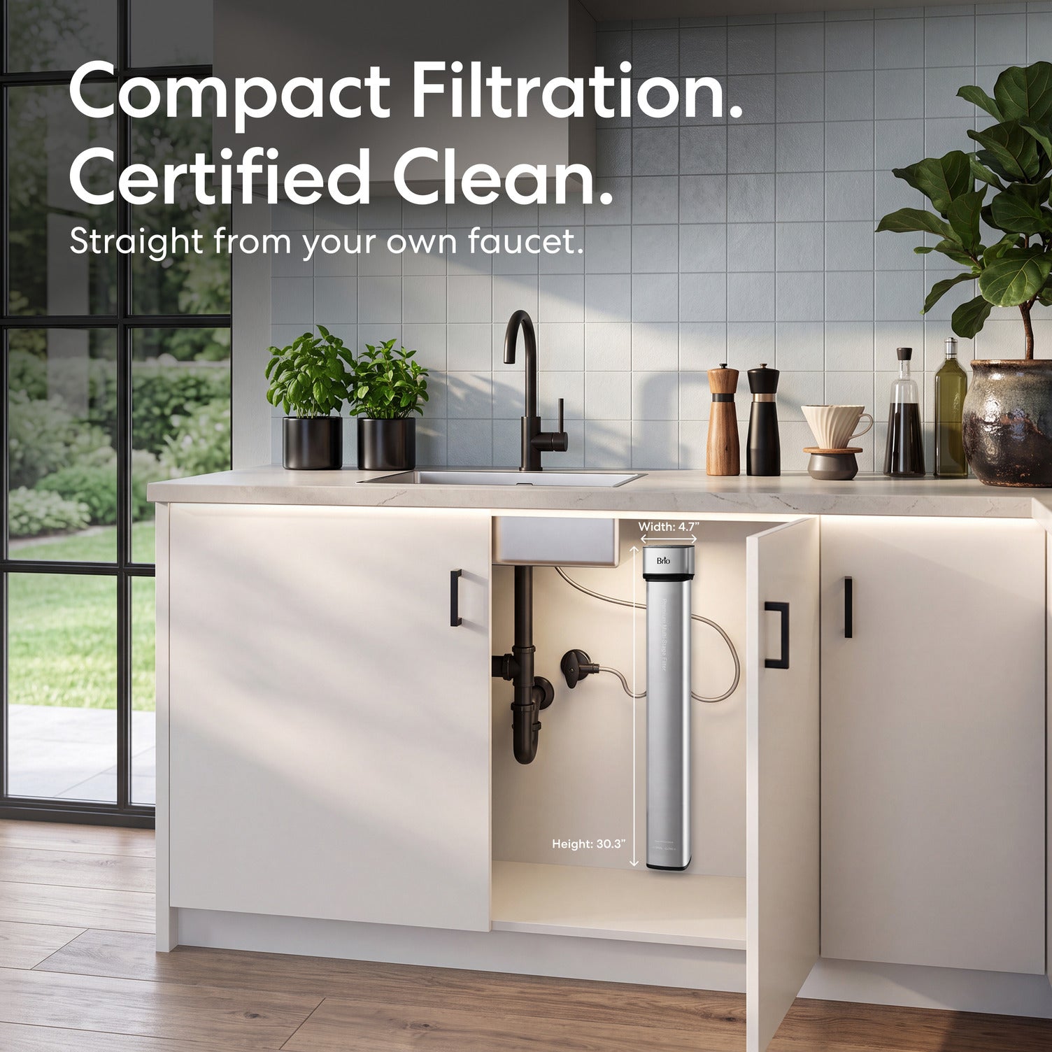The 26″ Premium Under Sink Filter PFAS-Reduction System mounted on a white kitchen cabinet door, shown in a bright modern kitchen with the text 'Compact Filtration. Certified Clean.