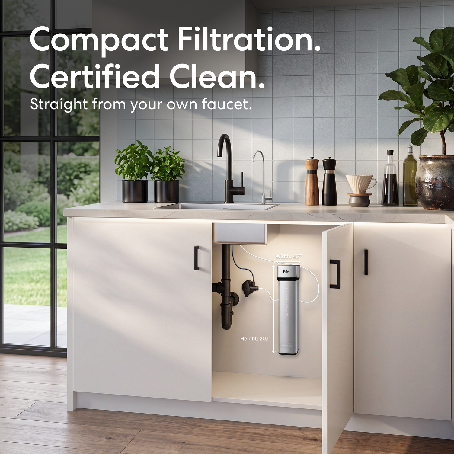 The 16″ Premium Under Sink Filter PFAS-Reduction System with stainless steel faucet mounted on a white kitchen cabinet door, shown in a bright modern kitchen with the text 'Compact Filtration. Certified Clean.