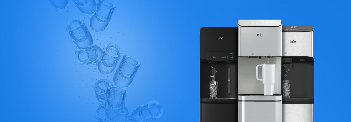 Three Brio water dispensers with built-in ice makers against a bright blue background with oversized ice cubes tumbling through bubbles. From left to right: the black 320 Ice dispensing ice into a glass, the stainless steel Moderna + Ice filling a white tumbler with water, and the silver 520 Ice dispensing ice into a glass.